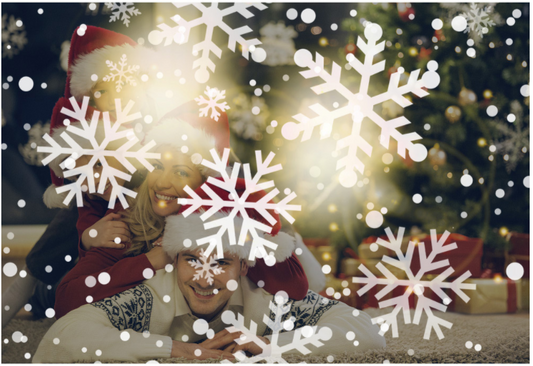 Snowflakes projected across a Christmas scene