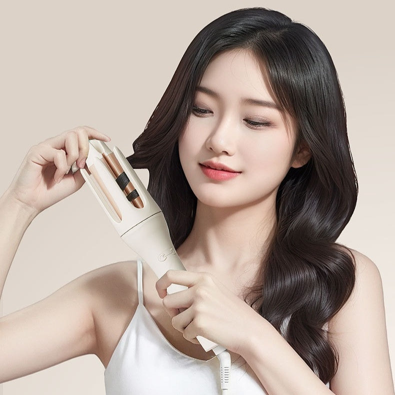 Automatic curling wand being used